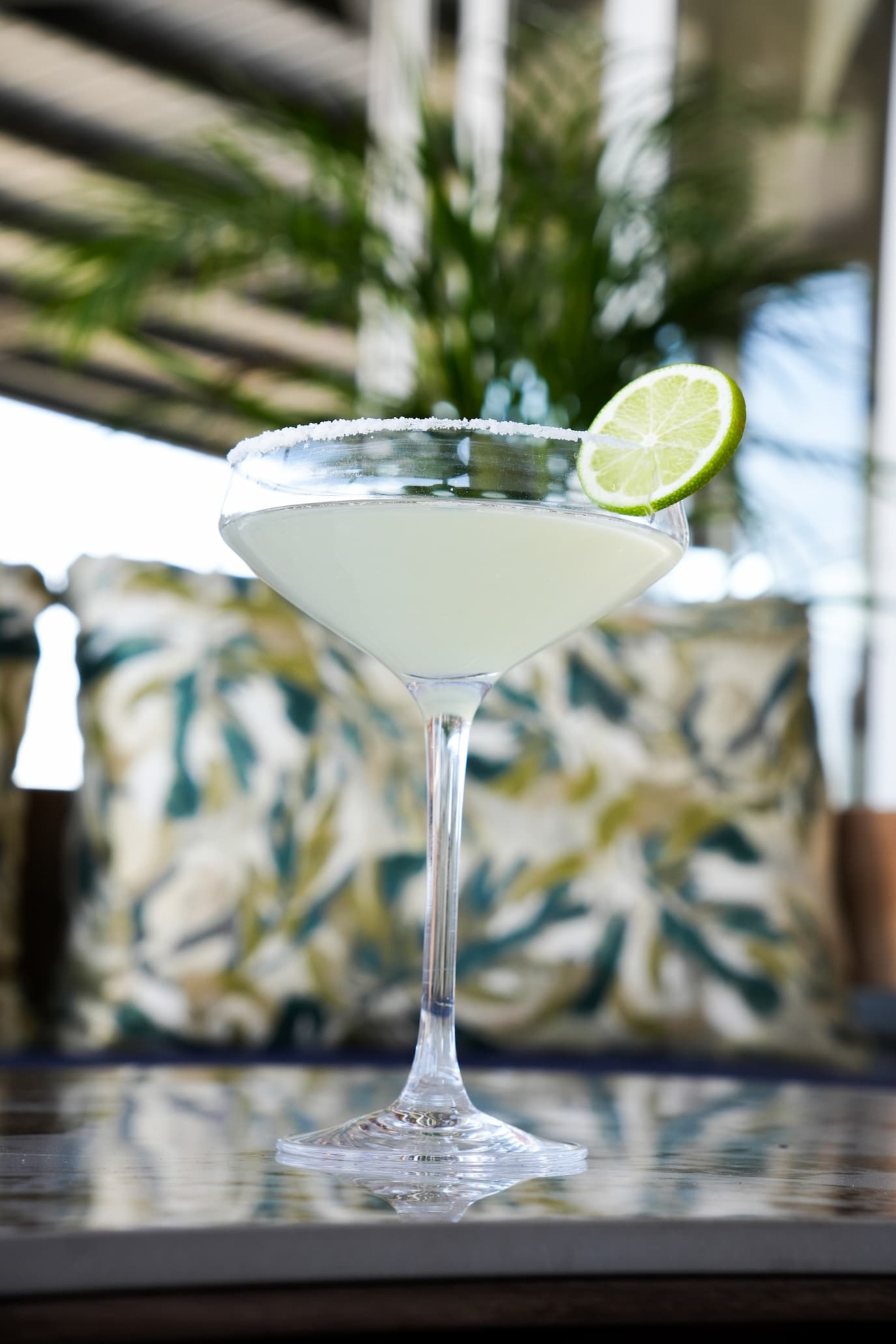Cocktail in a coupe glass with lime